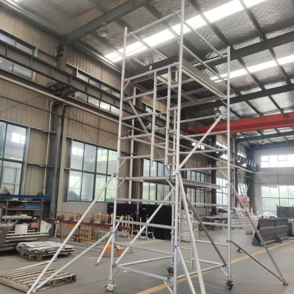 Mobile scaffolding tower assembled inside factory workshop