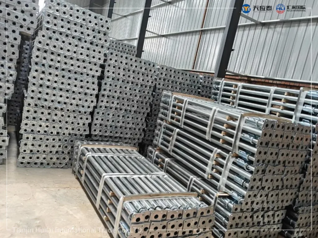 Bundled galvanized steel props stacked in workshop before Africa shipment