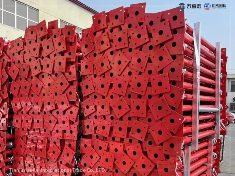 Red Q235 steel props stacked at factory for Ecuador industrial scaffolding project