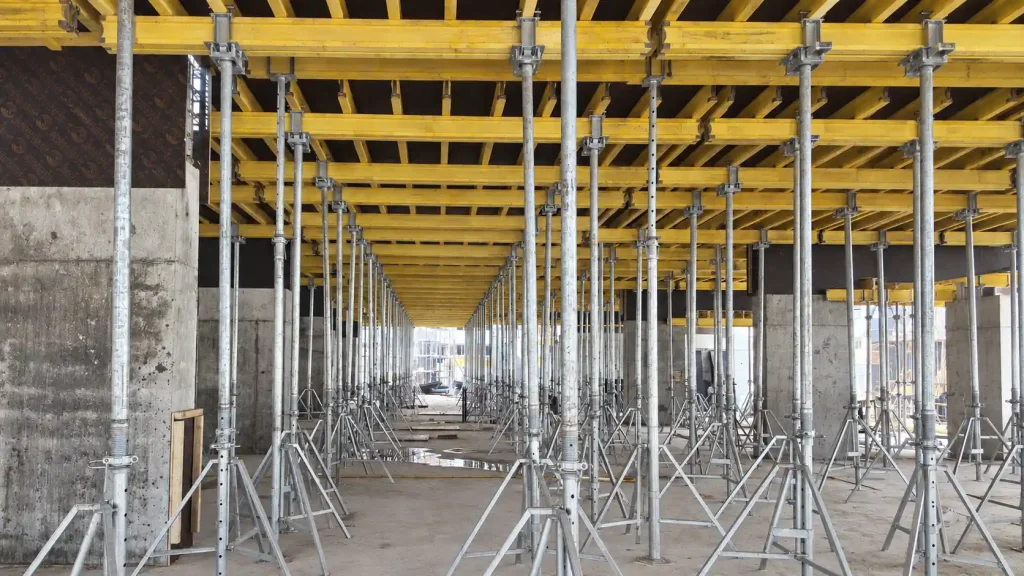 Adjustable steel props supporting concrete slab formwork
